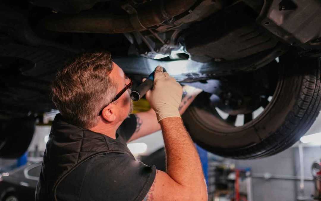 "Mechanic replacing complete rear axle assembly during drivetrain repair"